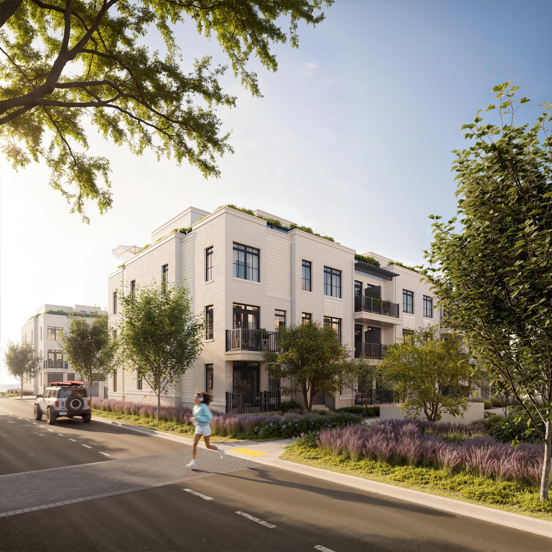 South Banks coastal townhomes along a tree-lined Lakeview Village street — artist's rendering